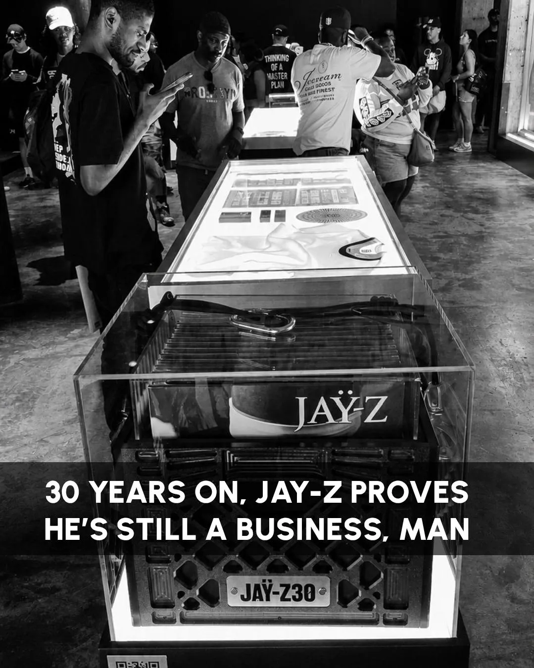 A milk crate and turntable sealed in a lightbox display case at the JAY-Z30 exhibition