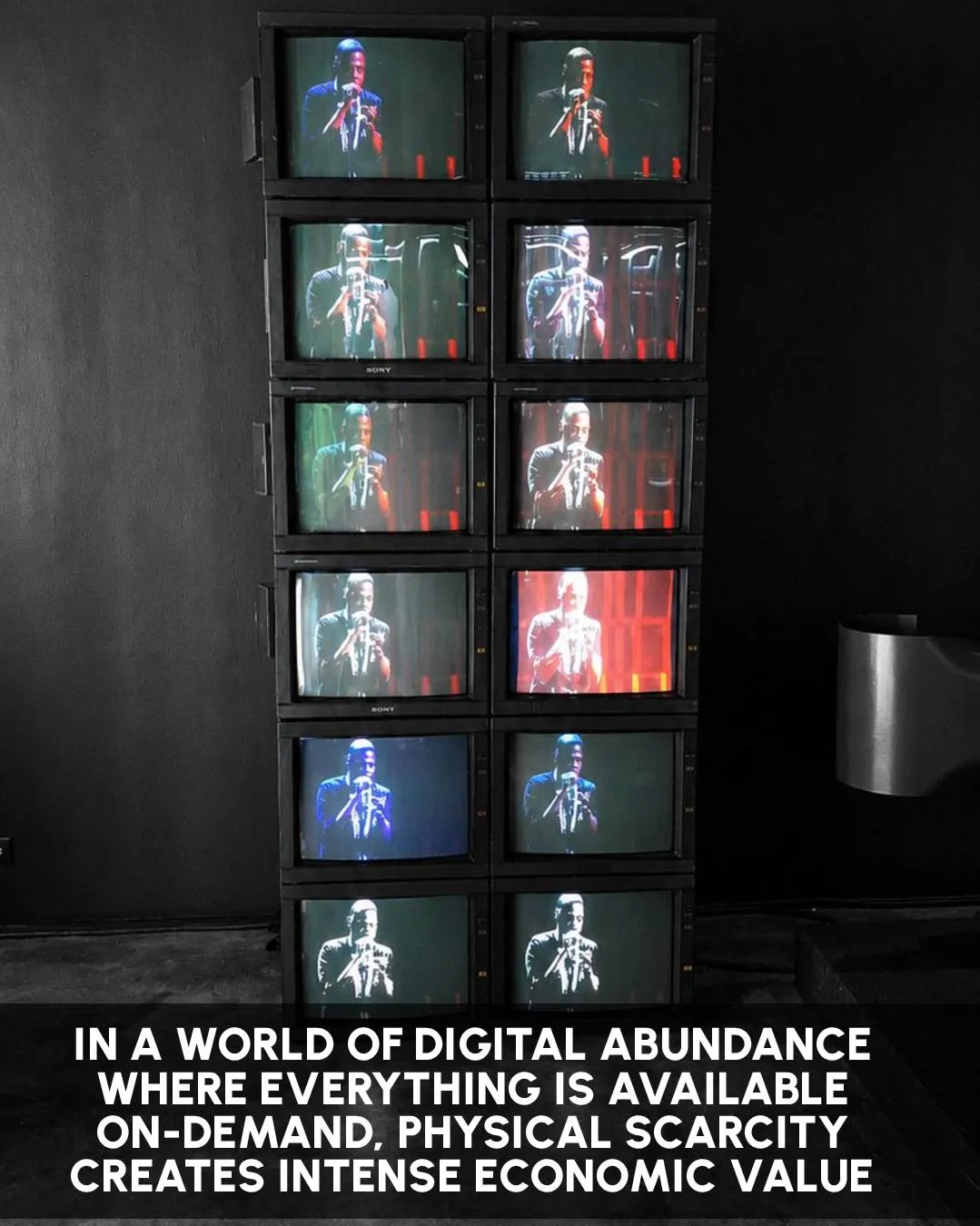 A tower of vintage televisions playing JAY-Z performances, a few screens glowing in colour